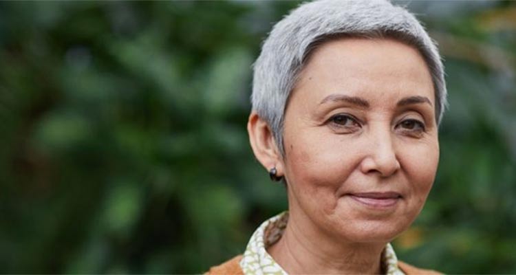 older woman in green background