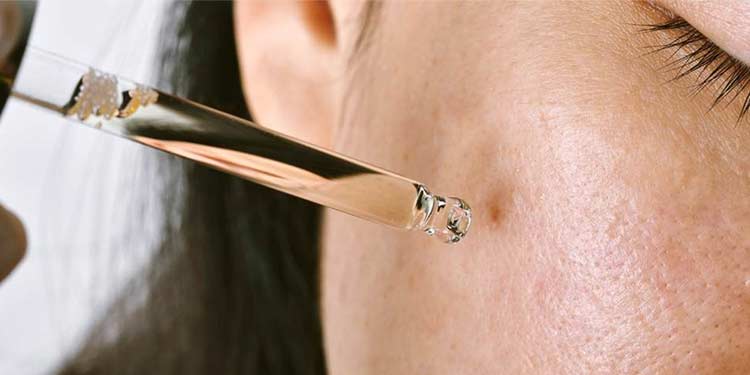 woman with dropper on skin
