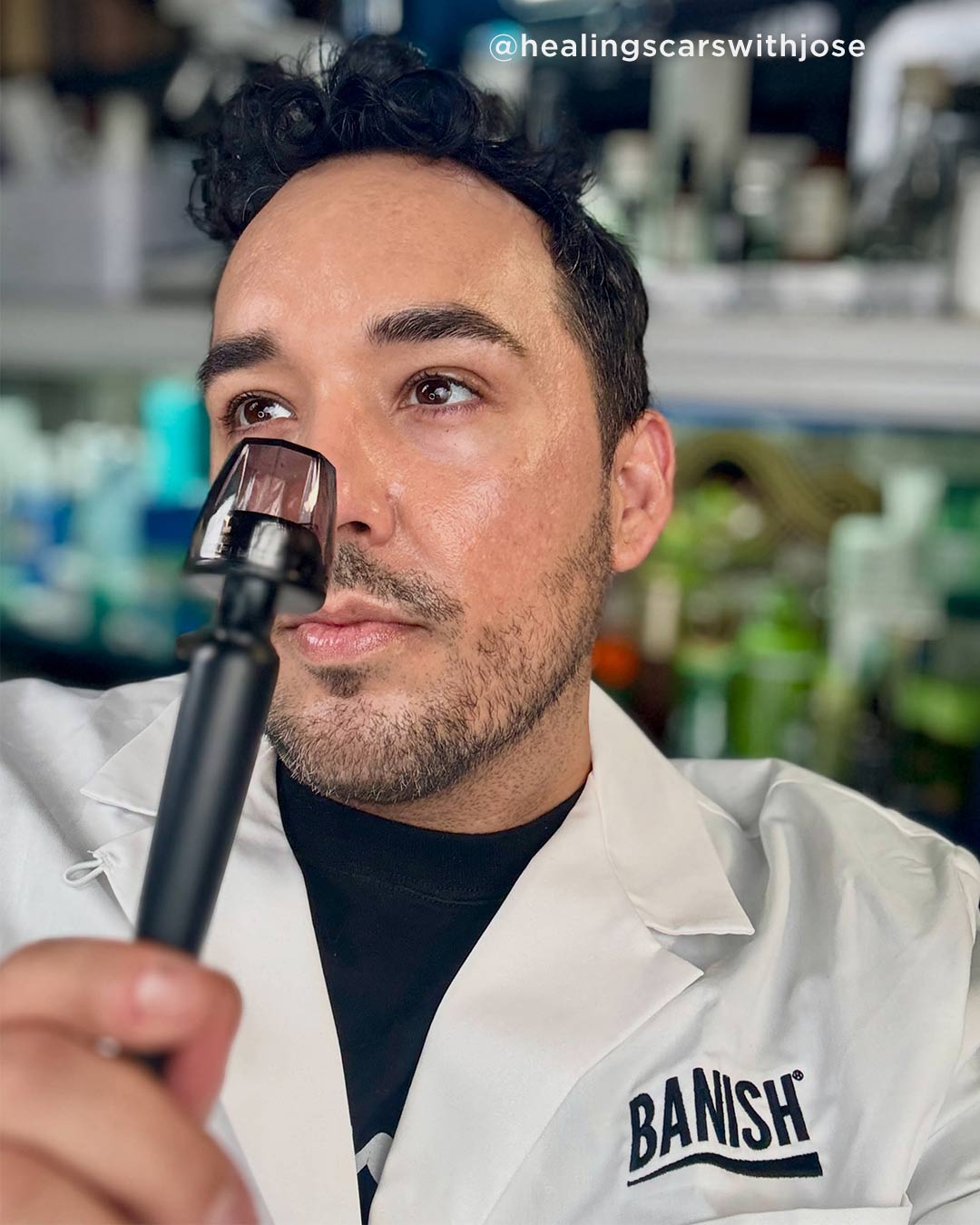 close up lifestyle shot of a man holding the Banisher 3.0 home microneedling tool